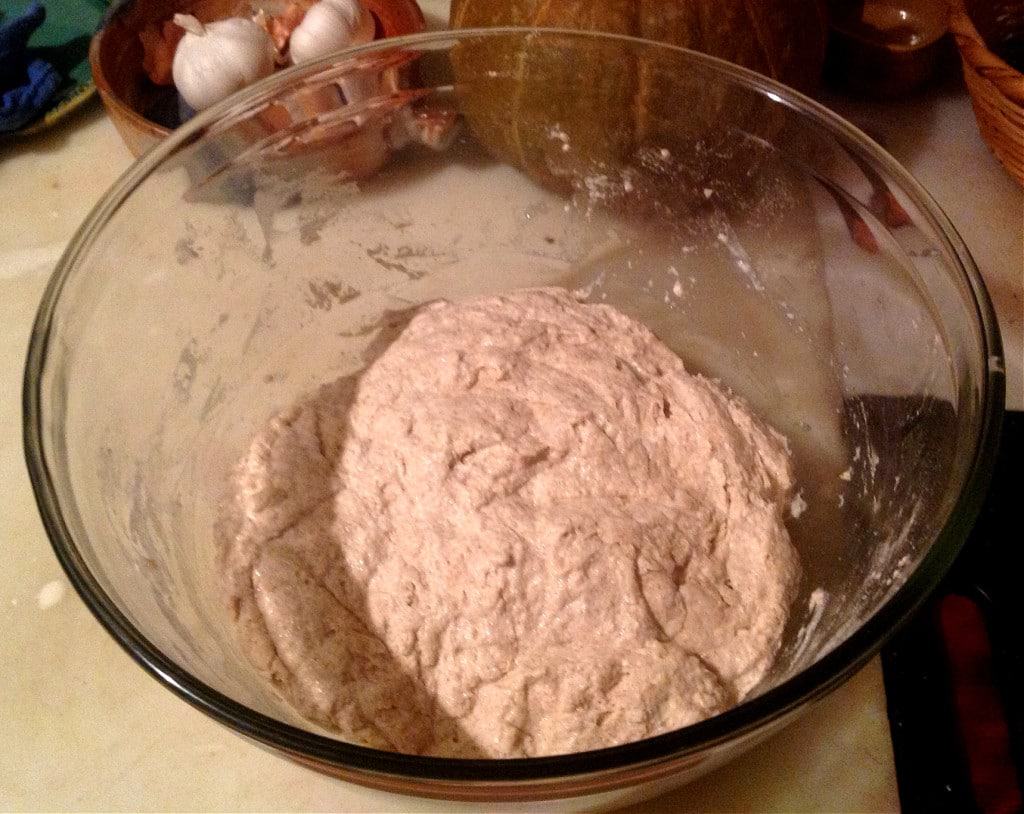 You won't believe how easy it is to make your own homemade sourdough bread with this no knead recipe! Using a homemade sourdough starter, and a few simple tools, this easy, sourdough bread is baked int a dutch oven with a foolproof recipe that comes out perfect every time. Transform your bread baking with this no knead sourdough bread recipe! #sourdough #sourdoughbread #noknead #bread #baking #realfood #traditionalfood no knead sourdough stir together dough
