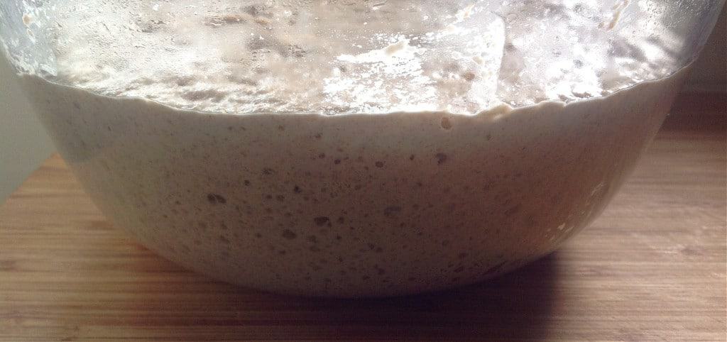 You won't believe how easy it is to make your own homemade sourdough bread with this no knead recipe! Using a homemade sourdough starter, and a few simple tools, this easy, sourdough bread is baked int a dutch oven with a foolproof recipe that comes out perfect every time. Transform your bread baking with this no knead sourdough bread recipe! #sourdough #sourdoughbread #noknead #bread #baking #realfood #traditionalfood no knead sourdough bread bubbles