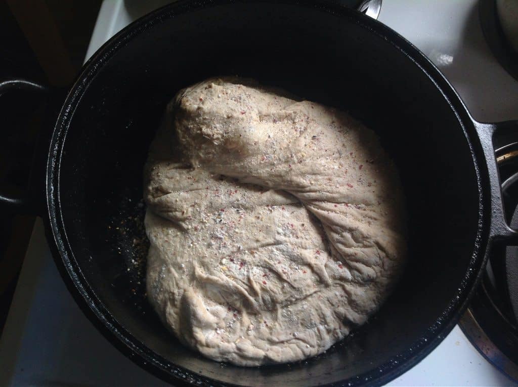 You won't believe how easy it is to make your own homemade sourdough bread with this no knead recipe! Using a homemade sourdough starter, and a few simple tools, this easy, sourdough bread is baked int a dutch oven with a foolproof recipe that comes out perfect every time. Transform your bread baking with this no knead sourdough bread recipe! #sourdough #sourdoughbread #noknead #bread #baking #realfood #traditionalfood put no knead sourdough in dutch oven