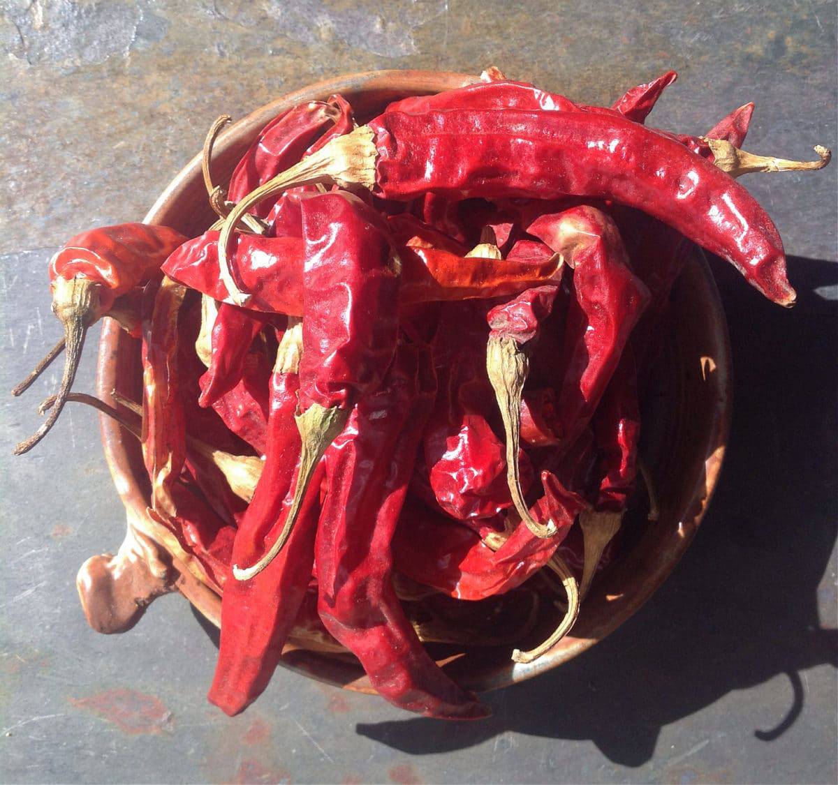 dried red ristra peppers in a bowl