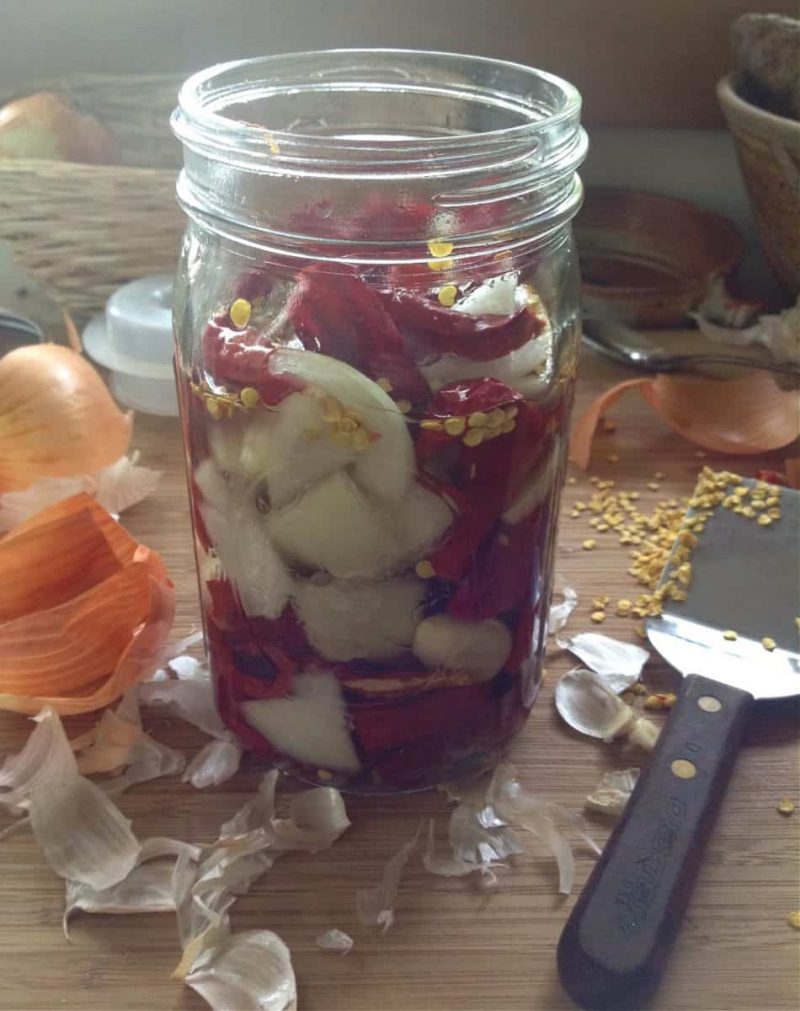 peppers and onions in a jar to ferment