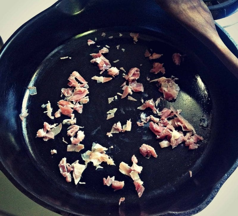 pancetta cooking in a cast iron skillet