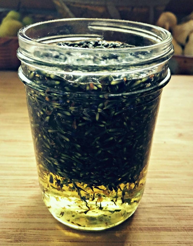 a small jar of dried lavender in oil