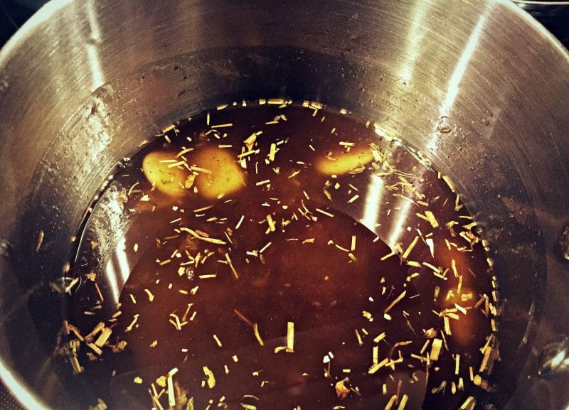 beeswax melting into the oil and herbs mixture