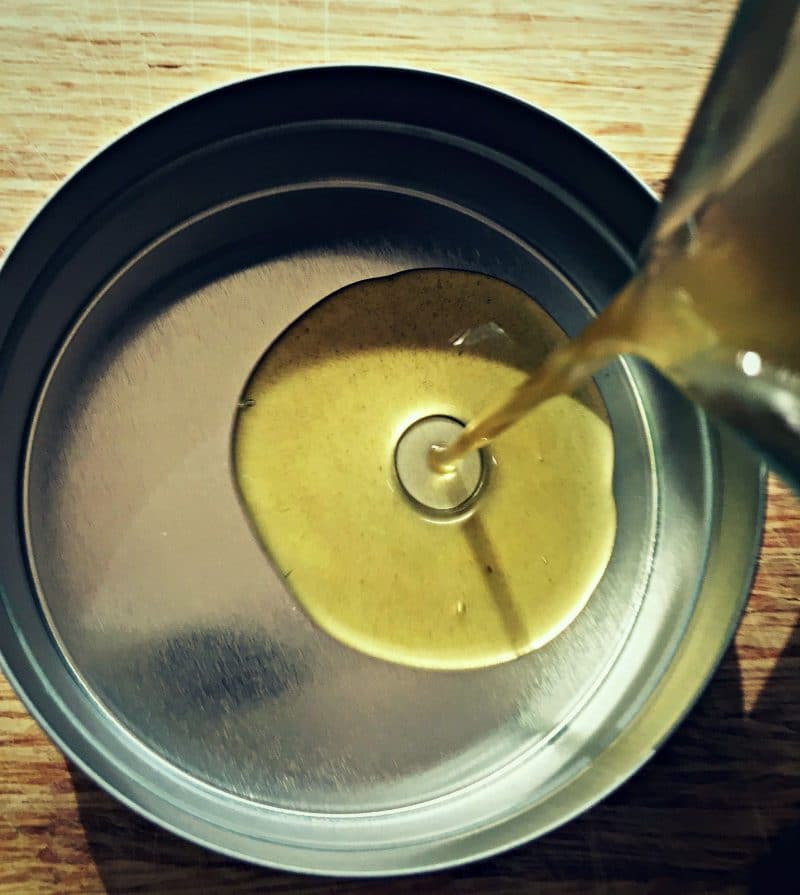 pouring the diaper rash salve into tins