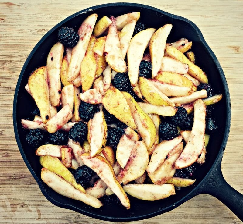 cast iron skillet with pears and blackberries