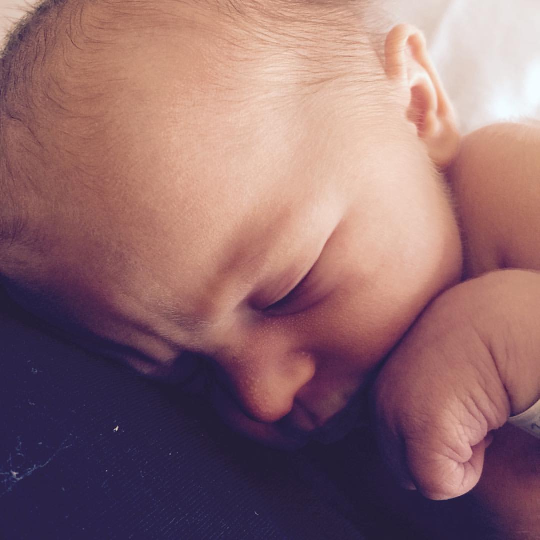 close up of a sweet baby's face and hand