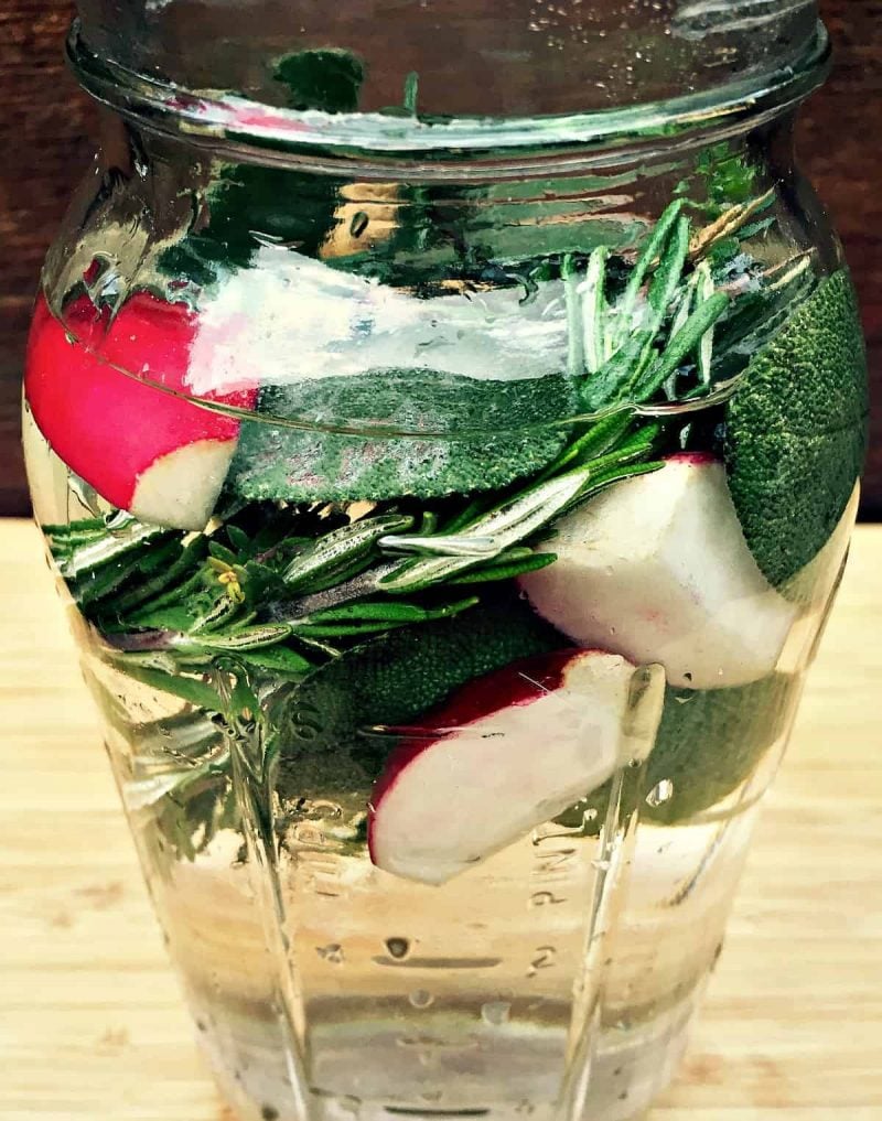A jar of kvass with herbs floating at the top. 