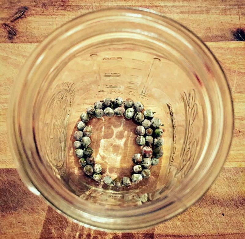 juniper berries in a quart jar