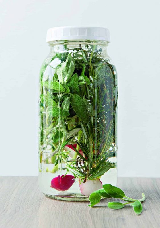 Winter is the perfect time to make this herb kvass! It's a bubbly, fermented drink that is traditionally made with beets, but can be made with any vegetable that ferments well. This recipe calls for a few handfuls of winter herbs and a radish. This fermented probiotic beverage is a wonderful winter drink to serve for the holidays or to give as a gift. #kvass #winter #drinks #healthydrinks #probiotics #ferment #fermented winter herb kvass book