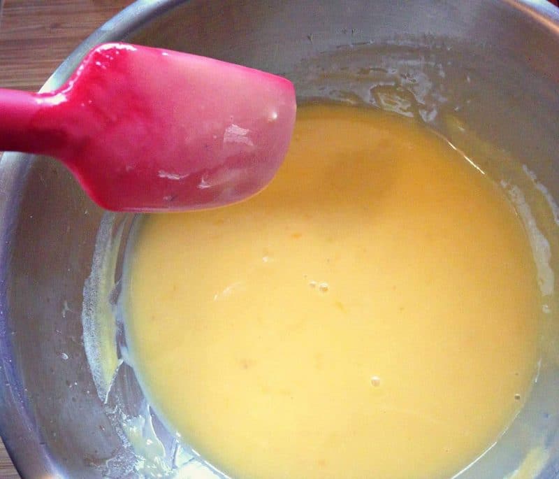 grapefruit curd coating the back of a spoon