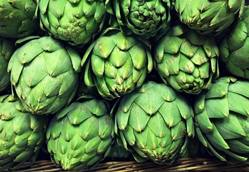 a display of fresh artichokes at the market