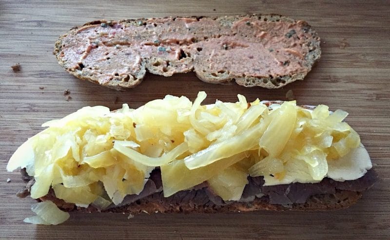 assembling the reuben sandwich with sauerkraut