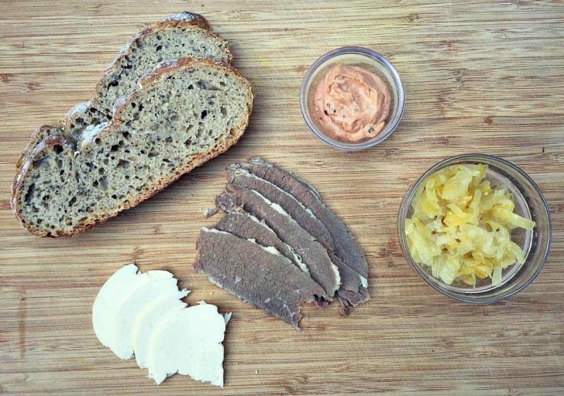 reuben sandwich ingredients on a cutting board