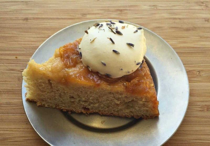 a slice of plum upside down cake with lavender whipped cream