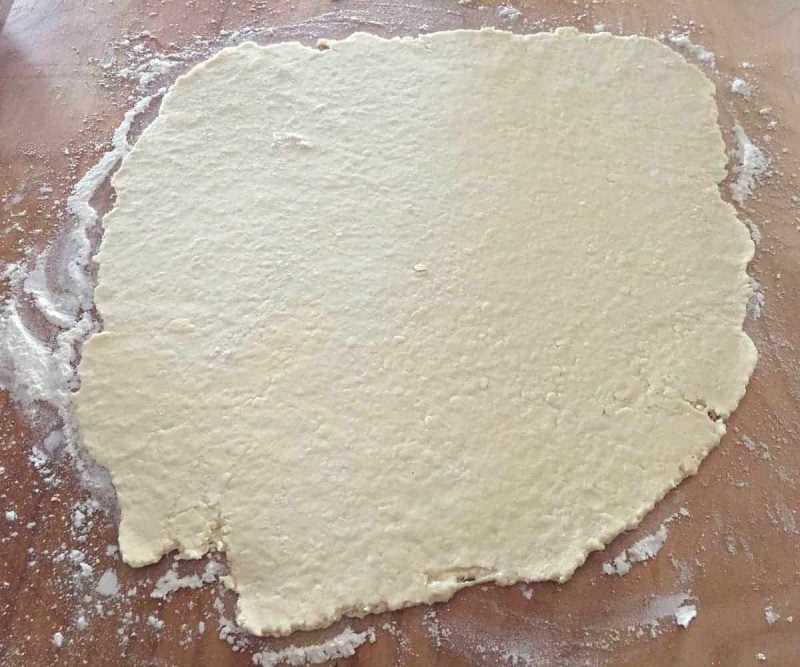 rolled out galette dough on a cutting board