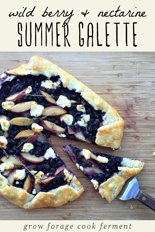 Wild berry nectarine galette with goat cheese on a wood cutting board.