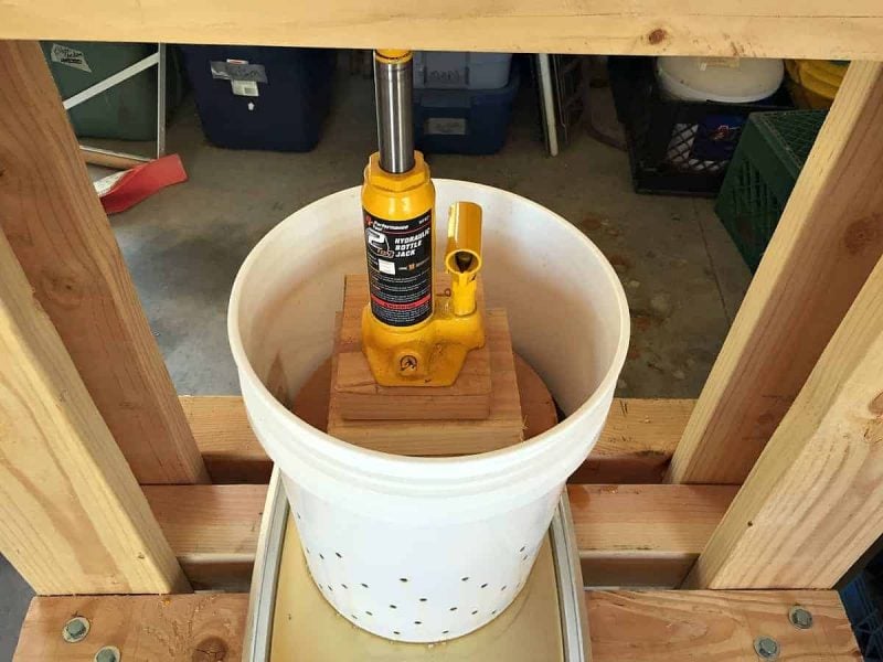 a jack pressing the apples in the DIY cider press