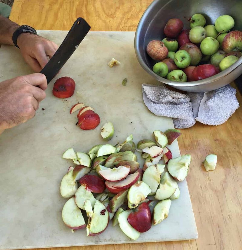 roughly chopping apples with a cleaver