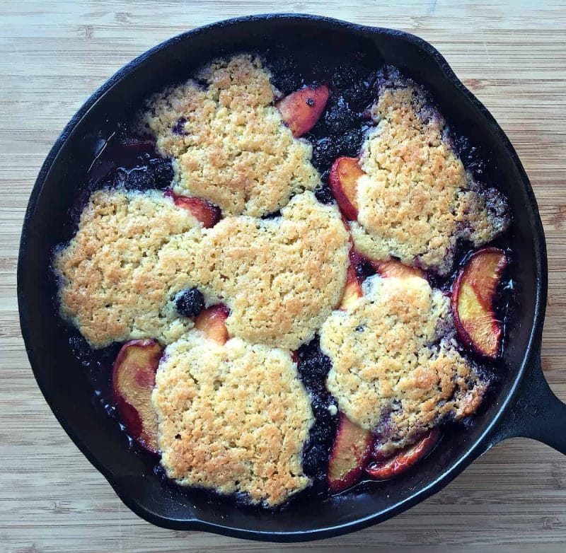 skillet peach blackberry cobbler on a table