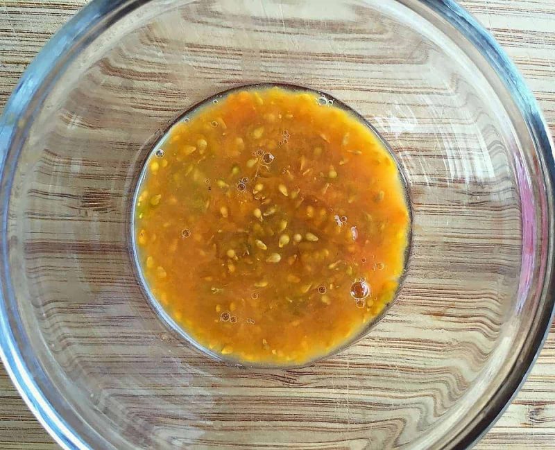 tomato seeds in a bowl to ferment for saving