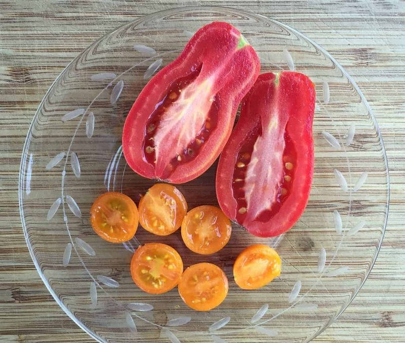 tomatoes cut in half on a plate