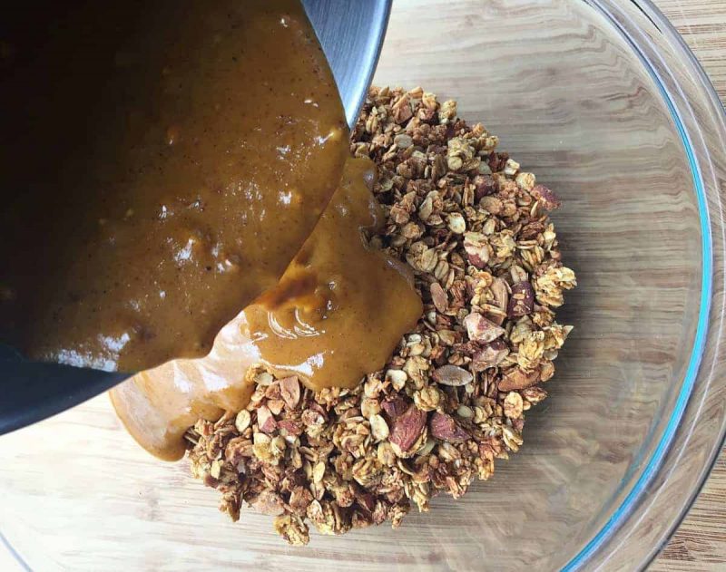 adding pumpkin mixture to granola