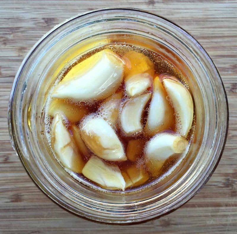 a jar of fermented garlic in honey