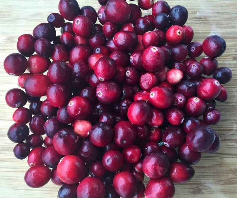 fresh cranberries on a wooden board