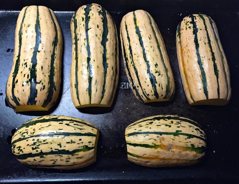 Roasting delicata squash cut side down.