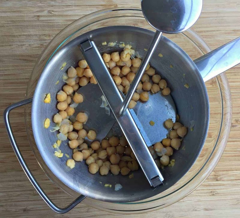 a food mill processing the chickpeas