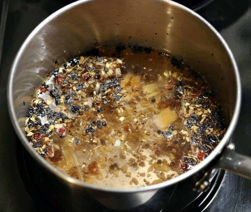 Herbal tea blend being steeped in a pot on the stove