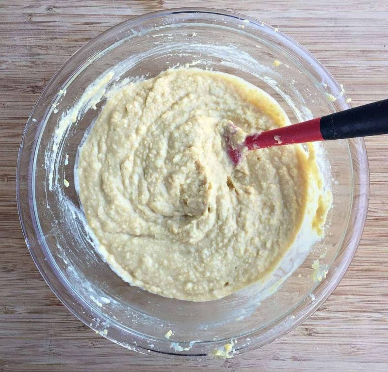 stirring the hummus together in a bowl