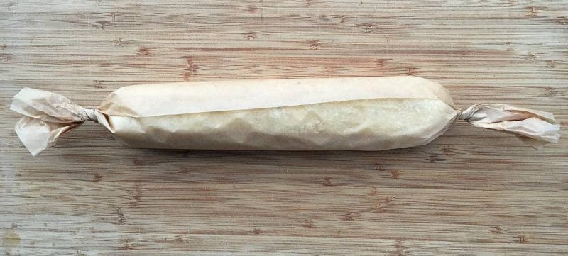 lemon lavender cookie dough log wrapped in parchment paper