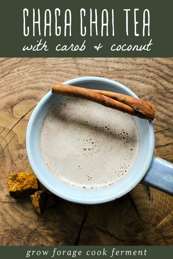 a mug of chaga chai tea with a cinnamon stick on a wooden board