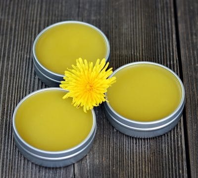 three tins of dandelion salve