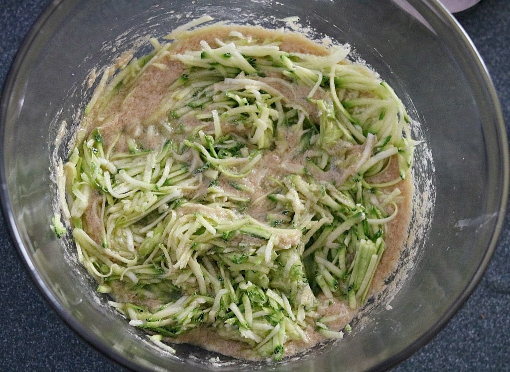 stirring the shredded zucchini into the batter