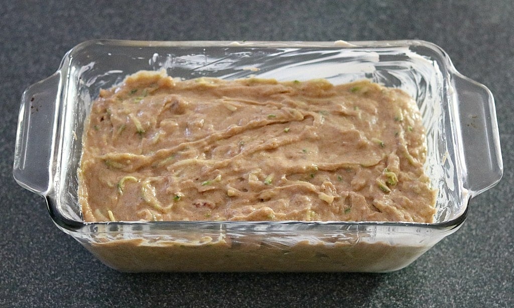 spreading the zucchini spice bread batter into the loaf pan
