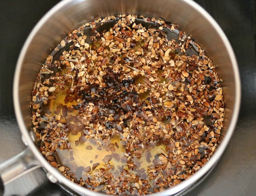 a pot on a stove making dandelion and chicory root coffee