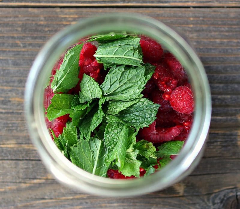 raspberries and mint in a quart jar