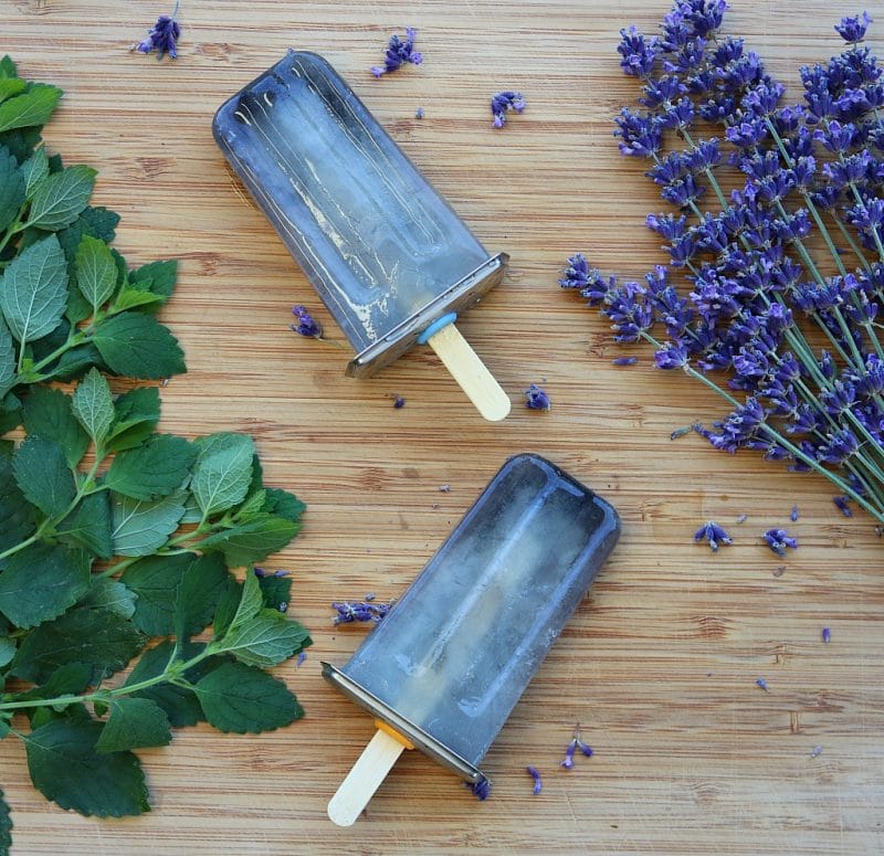 lemon balm and lavender popsicles on a wooden board