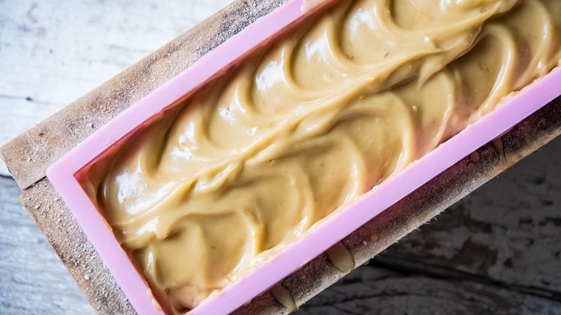 dandelion soap in a soap mold with swirls on top