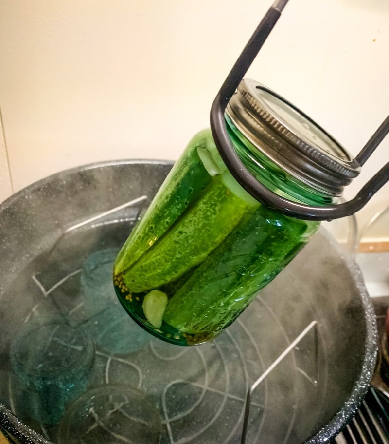 using jar lifter to put jar into the water bath canner