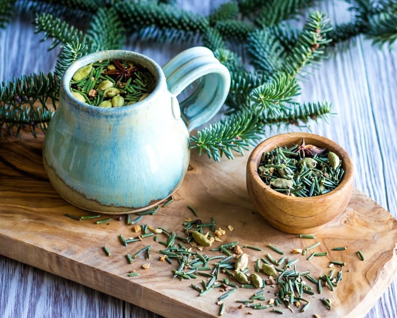 a mug and small bowl of fir needle chai