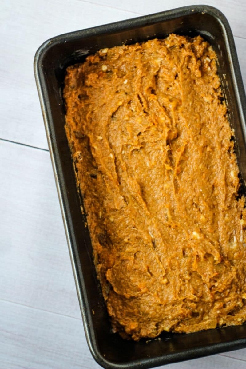 spreading persimmon bread into loaf pan