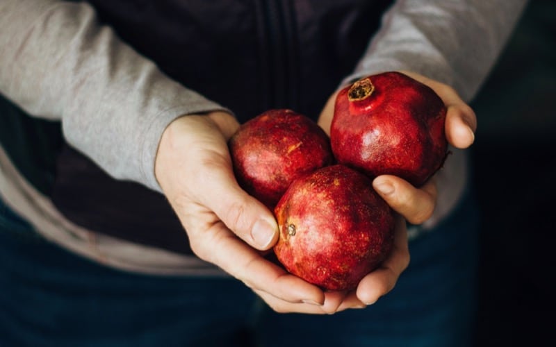 pomegranates in hand