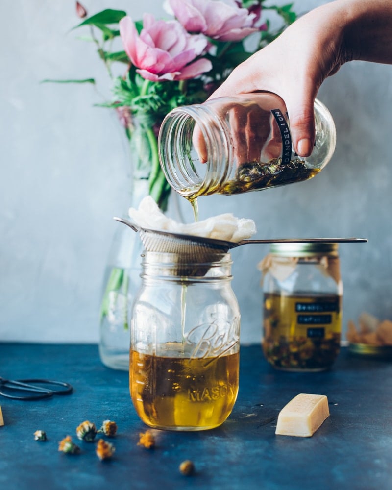 straining dandelion infused oil