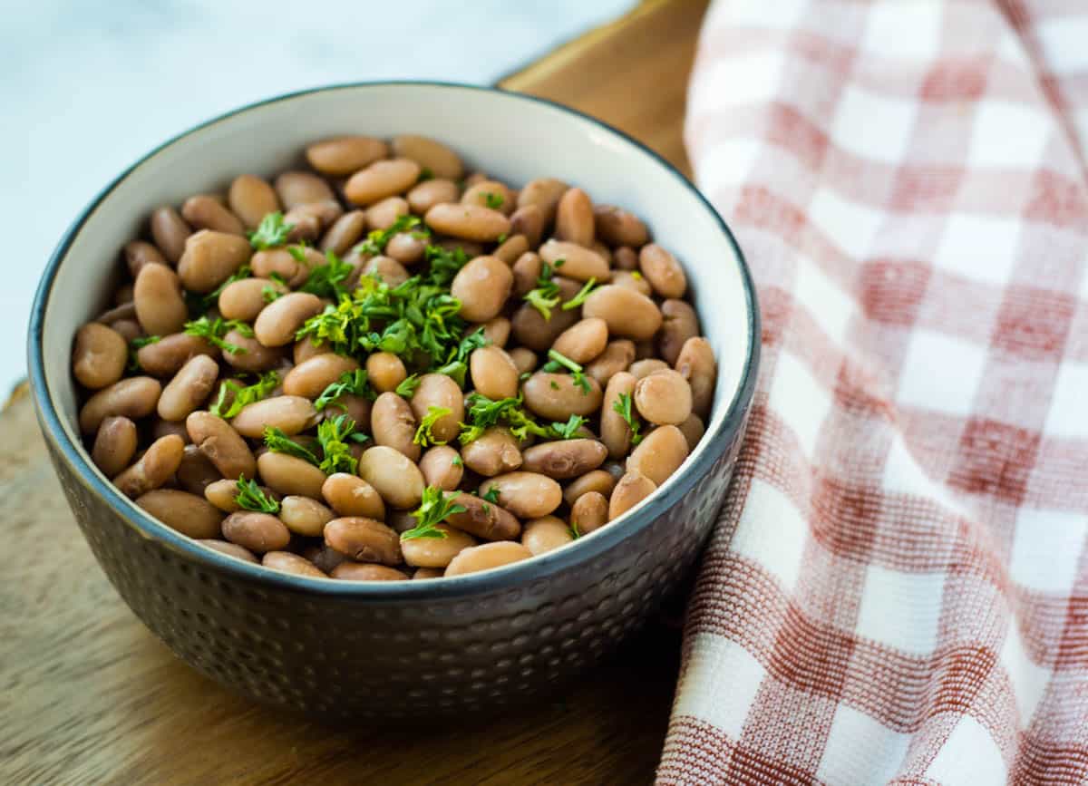 cooked beans in a bowl on a table