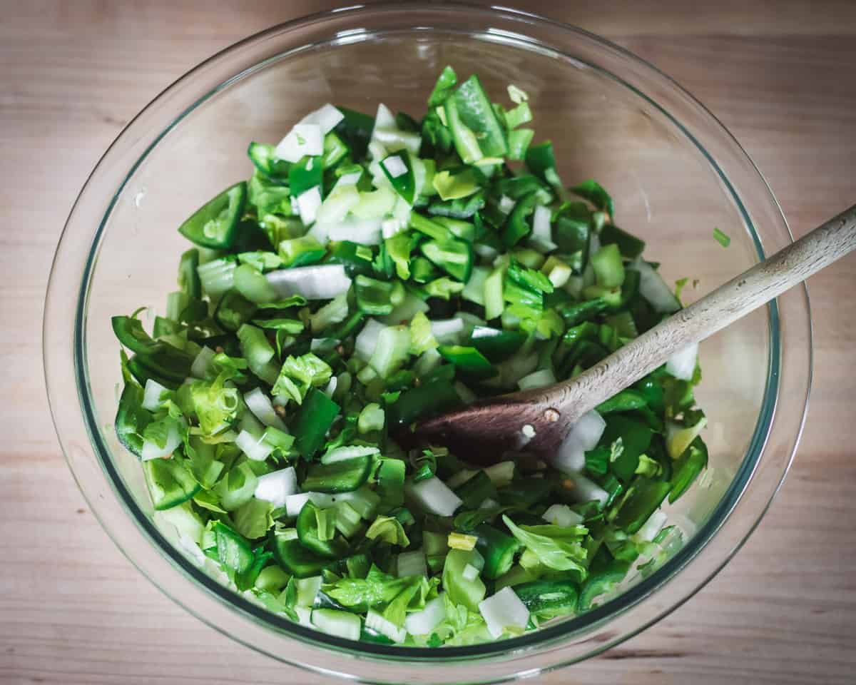 mixing vegetables to make fermented jalapeno hot sauce