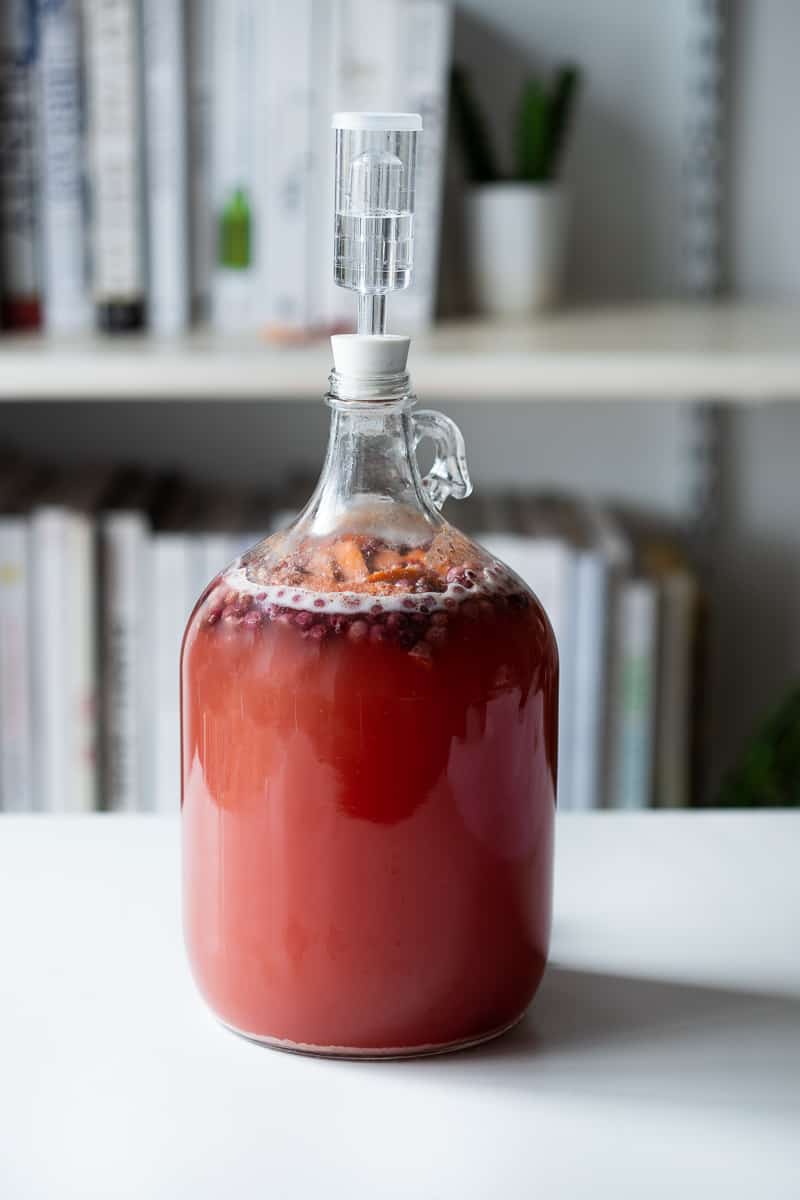 bubbles beginning to form in the jug of mead